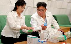 In this photo provided by the North Korean government, North Korean leader Kim Jong Un and his wife Ri Sol Ju prepare medicines at an unannounced place in North Korea Wednesday, June 15, 2022 to send them to Haeju City where an infectious disease occurred.