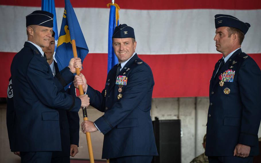Col. Kevin Crofton, incoming commander of the 52nd Fighter Wing, center, accepts the guidon flag from Maj. Gen. Derek France, Third Air Force commander, symbolizing the official transfer of command June 2, 2023, at Spangdahlem Air Base, Germany.