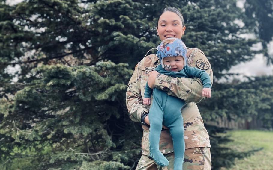 Carrie Vargas, an Army human resources sergeant stationed at Joint Base Lewis McChord, Wash., holds her 10-month-old son Keanu, who was born with a congenital heart defect. The challenges that Vargas experienced caring for him helped an Army group rewrite parent-related policies. The service made public on Thursday, April 21, 2022, the 23-page directive of new policies.