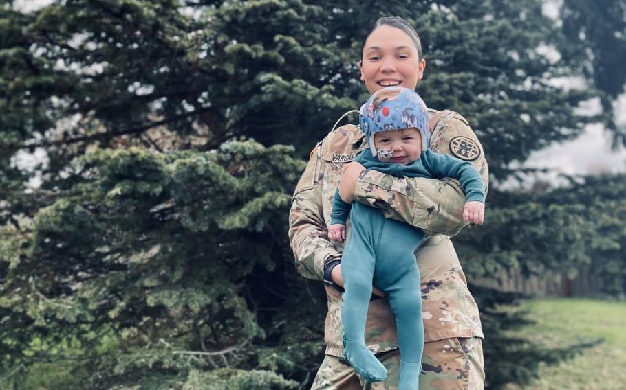 Carrie Vargas, an Army human resources sergeant stationed at Joint Base Lewis McChord, Wash., holds her 10-month-old son Keanu, who was born with a congenital heart defect. The challenges that Vargas experienced caring for him helped an Army group rewrite parent-related policies. The service made public on Thursday, April 21, 2022, the 23-page directive of new policies.