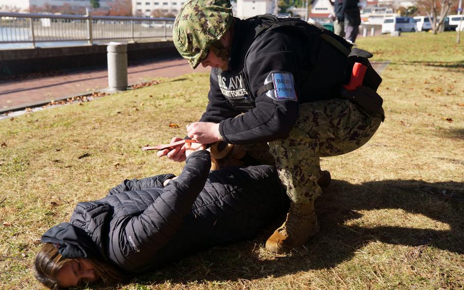 A U.S. Navy sailor apprehends a Kansas City Navy reservist acting as an active shooter during a drill at Yokosuka Naval Base, Japan, on Nov. 17, 2022. 