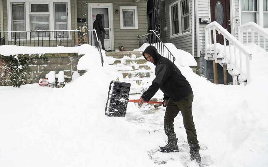 Ahmed Osman shovels his walk on the West Side, Saturday, Nov. 19, 2022, in Buffalo, N.Y. Residents of northern New York state are digging out from a dangerous lake-effect snowstorm that had dropped nearly 6 feet of snow in some areas and caused three deaths. The Buffalo metro area was hit hard, with some areas south of the city receiving more than 5 feet by early Saturday.