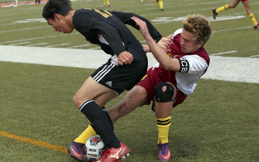 Yokota's Julian Tucker and Perry's Kirby Kendrick tangle for the ball during Wednesday's boys Division II playoff game. The Panthers won 3-0.