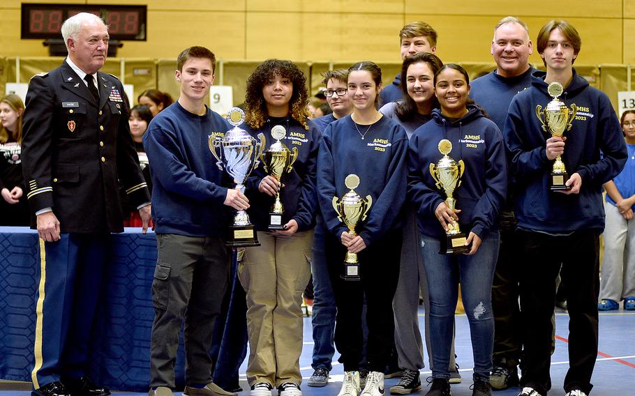 The Ansbach Cougar marksmanship team poses with its five trophies during the awards ceremony at the conclusion of the DODEA European marksmanship championship on Saturday at Wiesbaden High School in Wiesbaden, Germany. From left in front row are Collin Robertson, Laysha Bobbitt, Emma Priner, Kalea Russell and Alexander Pohlman, and in the back left is coach Christopher Buchanan. Far left if retired Maj. Robert Hase, director of Army instruction for DODEA- Europe.