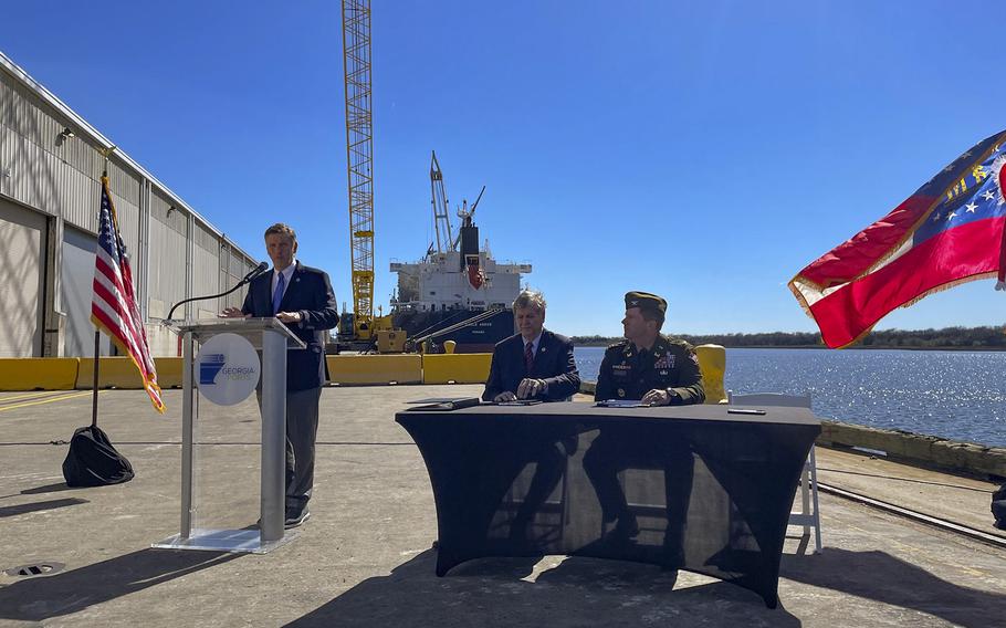 U.S. Army Corps of Engineers Commander, Col. Joseph Geary sits at a table during a signing ceremony in Brunswick, Ga., on Feb. 14, 2023, along with Georgia Ports Authority Board Chair, Joel Wooten, and GPA Executive Director, Griff Lynch.