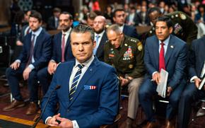 Justin Fulcher, far left, is seen at a Senate Armed Services Committee hearing on June 18 with Hegseth and other senior Pentagon officials. MUST CREDIT: Demetrius Freeman/The Washington Post