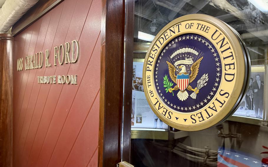 A door and presidential seal over a glass window.