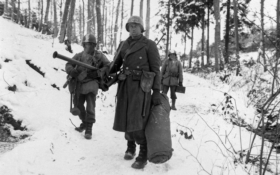U.S. Army engineers emerge from the woods and move out of defensive positions after fighting in the vicinity of Bastogne, Belgium, during the Battle of the Bulge.