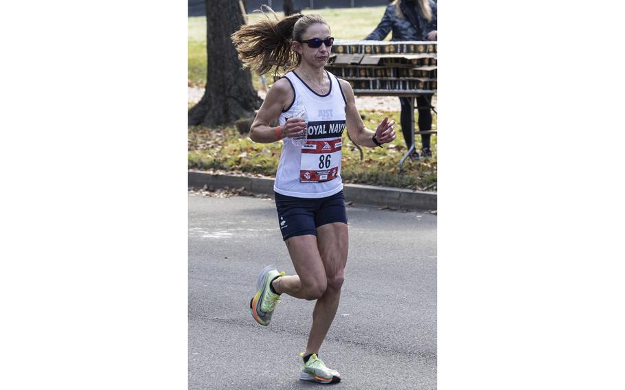 Eventual women’s champion Chelsea Baker of Stroud, Englan, passes a water station near the 16-mile mark of Sunday’s Marine Corps Marathon. Baker’s winning time was 2 hours, 42 minutes and 38 seconds, about five minutes ahead of runner-up Cara Sherman.