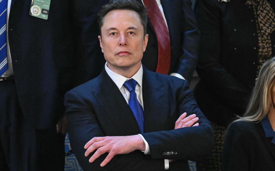 Elon Musk crosses his arms
