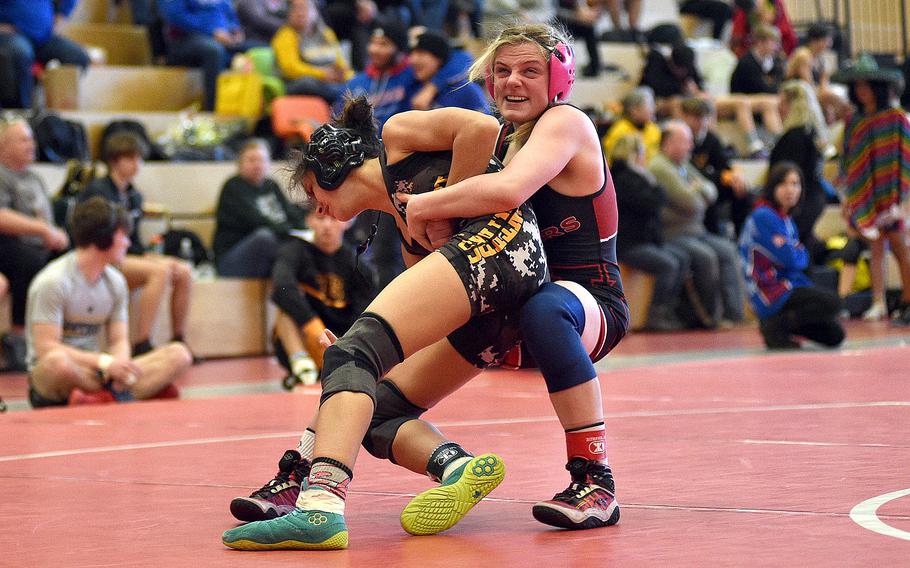 Kaiserslautern's Lily Greene attempts to throw Stuttgart's Karmyn Lopez during a 106-pound semifinal match at a wrestling meet on Jan. 27, 2024, at Kaiserslautern High School in Kaiserslautern, Germany.