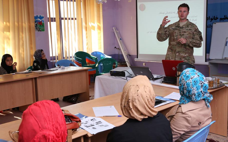 U.S. Navy Lt. j.g. Matthew Stroup, a public affairs officer, discusses photography with journalists during training in Farah, Afghanistan in 2013. The U.S. invested millions to support Afghan media.