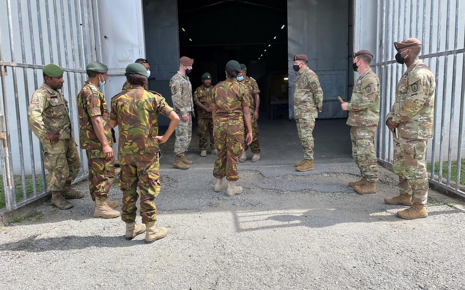 Papua New Guinea Defense Force personnel brief members of the Army's 5th Security Force Assistance Brigade at a supply warehouse on Murray Barracks, Papua New Guinea, May 24, 2021. 