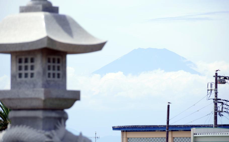 The summit of Mount Fuji is seen from Enoshima Beach in Fujisawa, Japan, Aug. 2, 2021. 