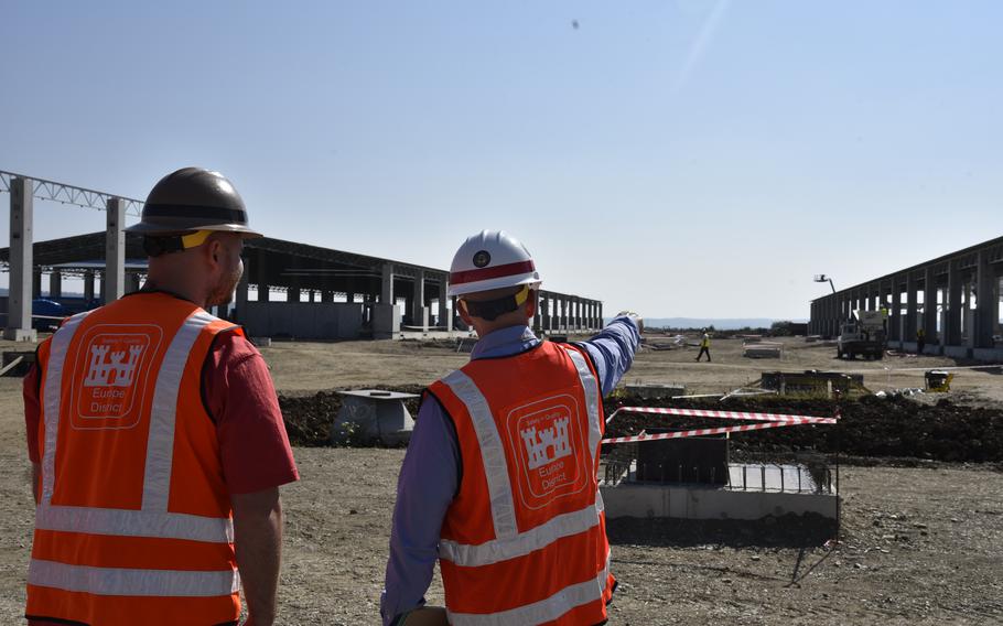 U.S. Army Corps of Engineers team lead Andrew Stanford and Roger Vogler, chief of engineering, discuss progress on construction at Air Base 71 near Campia Turzii, Romania, on Sept. 18, 2023. The project is part of a more than $100 million construction program at the base. 