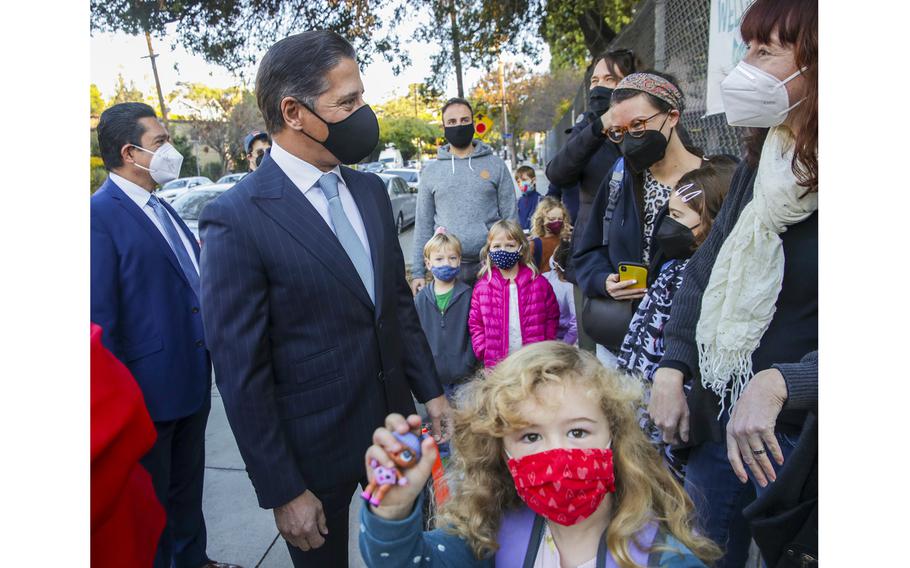 Los Angeles Unified Superintendent Alberto M. Carvalho, left, greets parents on his visit to Elysian Heights Elementary Arts Magnet on Friday, Jan. 14, 2022, in Los Angeles. 
