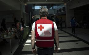 A representative from the Canadian Red Cross works at an evacuation centre where food and shelter is being provided for those forced from their homes due to the wildfire burning in suburban Halifax, Nova Scotia, on Tuesday, May 30, 2023.