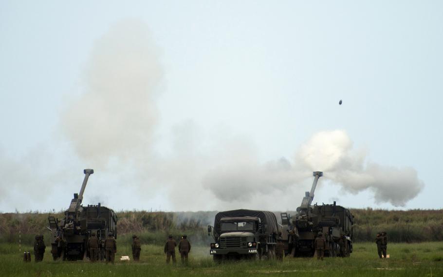 Philippine soldiers fire 155 mm truck-mounted howitzers during a Balikatan drill at Naval Station Leovigildo Gantioqui in San Antonio, Philippines, Wednesday, April 26, 2023.