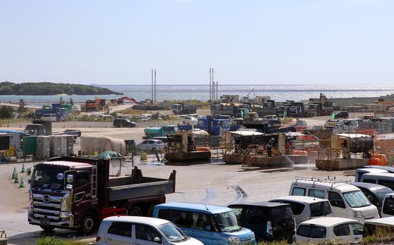 Vehicles move in and out of the construction zone for a Marine Corps runway being built at Camp Schwab, Okinawa, Japan, on Nov. 16, 2023.