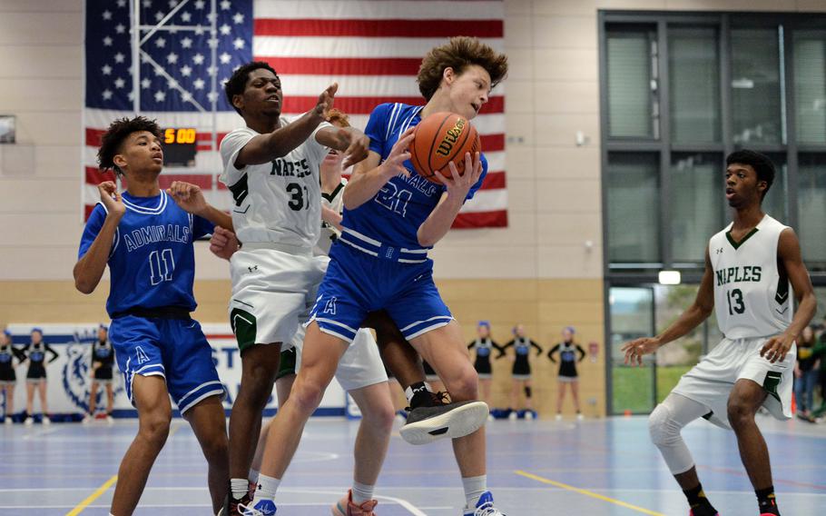 Rota’s Tyler DeMeritt grabs a defensive rebound against Naples’ Robert Oliver in the Division II championship game at the DODEA-Europe basketball finals in Ramstein, Germany, Feb. 18, 2023. Naples beat Rota 46-25 to take the division title.