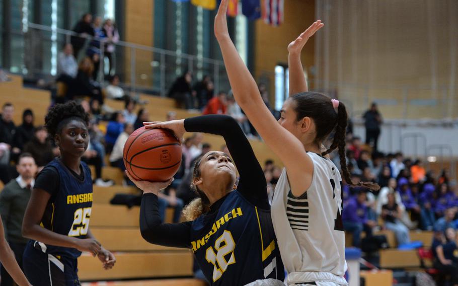 Ansbach’s Laila McIntyre looks for a shot against AFNORTH’s Rowan Moreno in the girls Division III final at the DODEA-Europe basketball championships in Wiesbaden, Germany, Feb. 17, 2024. AFNORTH took the title with a 34-23 win.