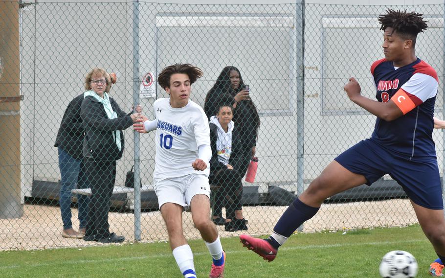 Sigonella's Santiago Rodriguez somehow manages to get the ball past Aviano's Terrance Johnson on Saturday, April 15, 2023.