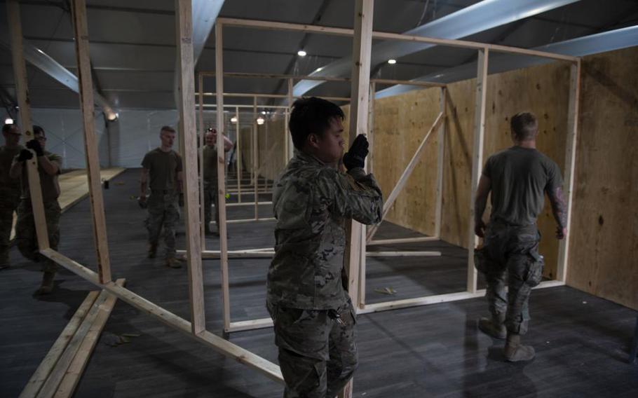 Airmen from Task Force-Holloman build partitions in a newly constructed living area at the Afghan personnel camp on Holloman Air Force Base, N.M., August 31, 2021.