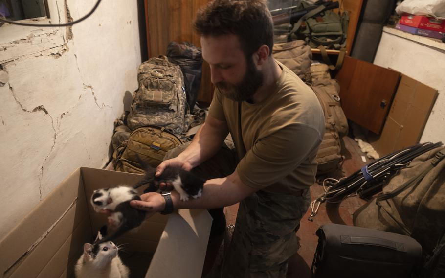 A Ukrainian soldier who goes by the call sign Chuck with a cat he rescued from Bakhmut. Some of the soldiers have nicknamed the cat Bakhmutka, after the city. 