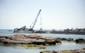 A crane moves material at the site of a future Marine Corps airfield at Camp Schwab, Okinawa, April 16, 2025.