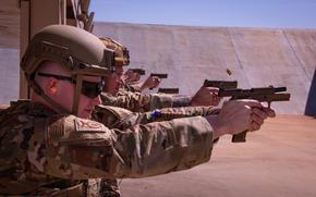 U.S. Air National Guard Airmen assigned to the 134th Security Forces Squadron fire 9mm rounds from an M18 handgun at paper targets, during a Combat Arms Training and Maintenance(CATM) exercise at McGhee Tyson Air National Guard Base, Tennessee, March 1, 2025. This training is part of an ongoing effort to ensure Airmen can safeguard resources anywhere, anytime. (U.S. Air National Guard Photo by Staff Sgt. Jesse Hanson)