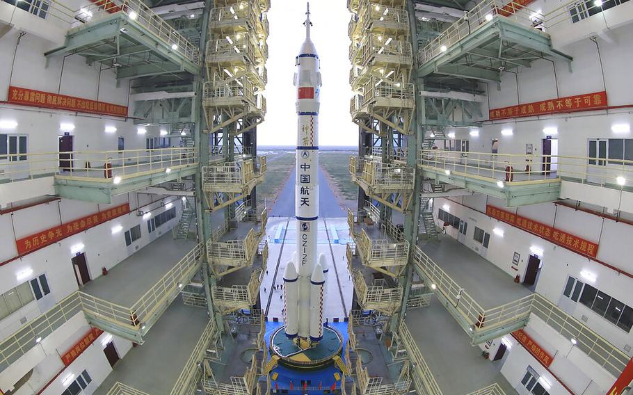 In this photo released by Xinhua News Agency, the Shenzhou-13 manned spaceship atop a Long March-2F carrier rocket prepares to be transferred to the launching area of Jiuquan Satellite Launch Center in northwestern China, Oct. 7, 2021.