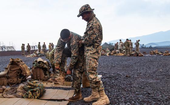 A Marine from Company B, 1st Battalion, 3rd Marine Regiment helps Pfc. Miguelangel Vasquez, 19. of Victorville, Calif., put on his boot at Pohakuloa Training Area, Hawaii, Wednesday, July 18, 2018. Early-morning grouchiness is a way of life, said Vasquez. “We complain 100 percent of the time,” he said has he pulled on his boots with the help of a fellow “boot,” as new Marines are called.

RELATED: Early morning grouchiness a way of life for RIMPAC Marines. https://www.stripes.com/theaters/asia_pacific/early-morning-grouchiness-a-way-of-life-for-rimpac-marines-1.540976

META TAGS: U.S. Marine Corps; USMC; Hawaii; exercise; Rim of the Pacific; RIMPAC