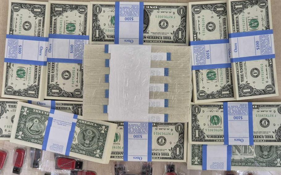 American dollar bills and USB thumb drives are prepared for balloon flights into North Korea by South Korean activists on June 6, 2024. 