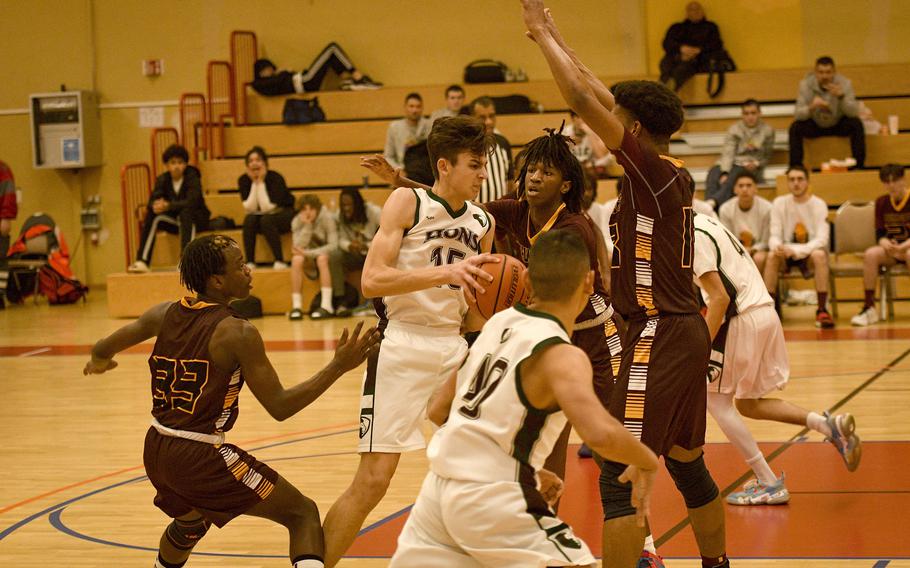 AFNORTH’S Nathan Goldsmith drives into a swarm of Baumholder defenders during a DODEA-Europe Division III basketball semifinal game Feb. 17, 2023, in Baumholder, Germany.