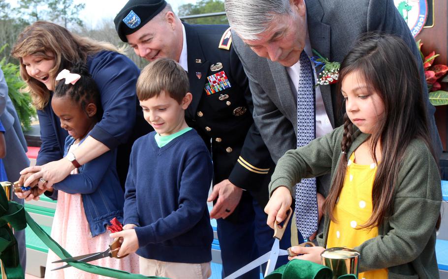 Department of Defense Education Activity director Thomas Brady, right, helps open the new Pierce Terrace Elementary School at Fort Jackson, S.C., Feb. 12, 2020. Brady is retiring at the end of the school year after heading DODEA since 2014.
