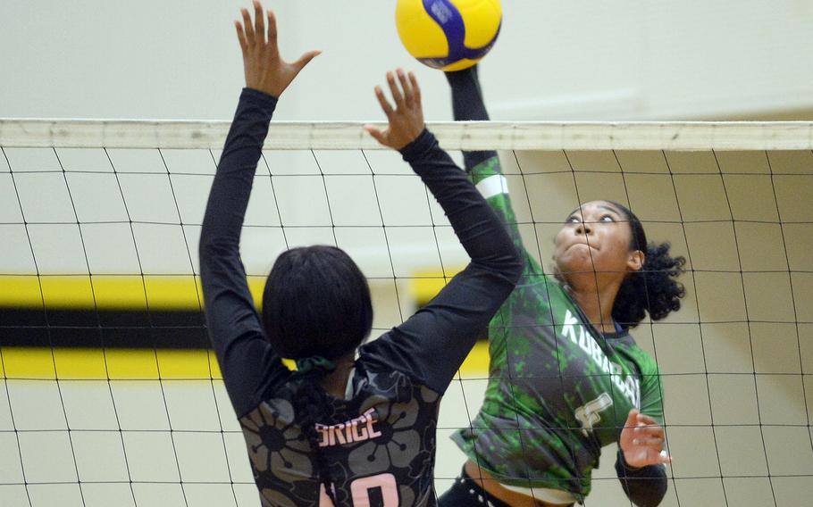 Kubasaki's Risha McGriff spikes against Nile C. Kinnick's Ja'lilah Brice.