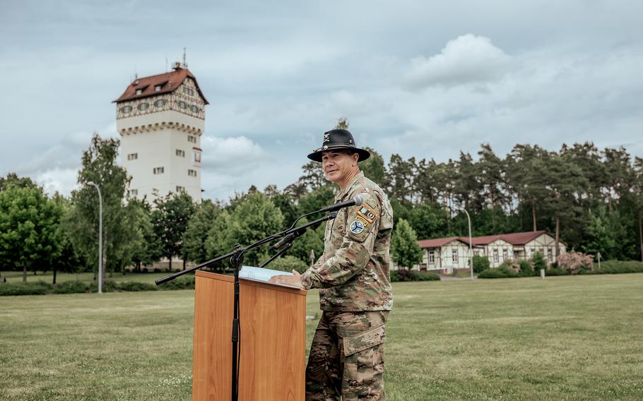 A uniformed soldier speaks from behind a podium.
