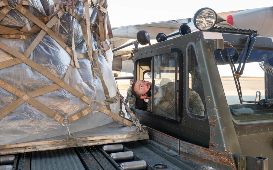 Senior Airman Joseph Bittle, a 436th Aerial Port Squadron ramp specialist, loads ammunition, weapons and other equipment bound for Ukraine during a foreign military sales mission at Dover Air Force Base, Del., on Jan. 27, 2022. 