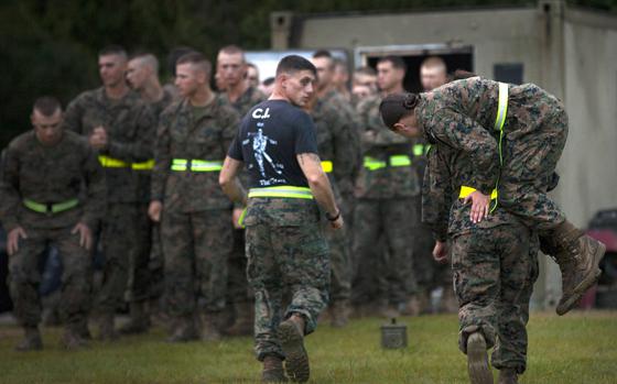 A female service member carries a counterpart during the movement-under-fire portion of the Combat Fitness Test at Marine Corps Base Camp Geiger, N.C., in 2013. Researchers concluded that lower fitness levels at the start of basic training and women's greater likelihood of reporting injuries were likely factors in the higher injury rates of female personnel.

