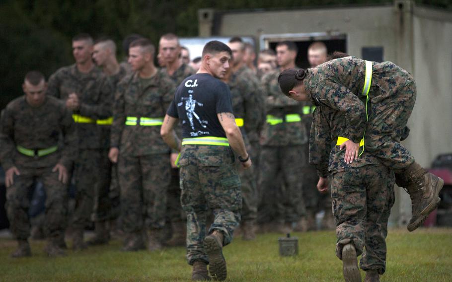 A female service member carries a counterpart during the movement-under-fire portion of the Combat Fitness Test at Marine Corps Base Camp Geiger, N.C., in 2013. Researchers concluded that lower fitness levels at the start of basic training and women's greater likelihood of reporting injuries were likely factors in the higher injury rates of female personnel.