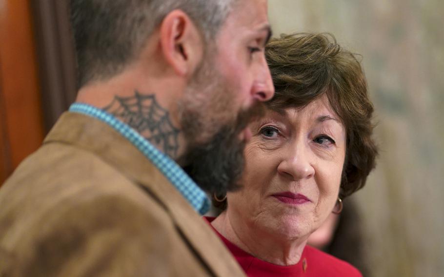 Sen. Susan Collins, R-Maine, with D.C. police officer Michael Fanone in May. 