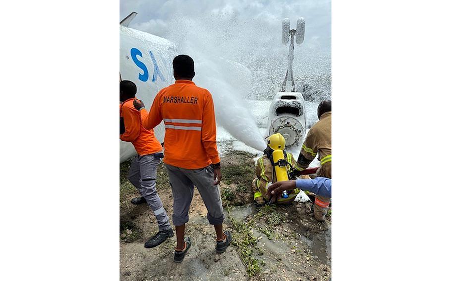 First responders extinguish a fire on a Jubba Airlines plane July 18, 2022, at Mogadishu International Airport in Somalia. Three U.S. soldiers out of Fort Bragg, N.C., participated in the medical response following the plane crash.