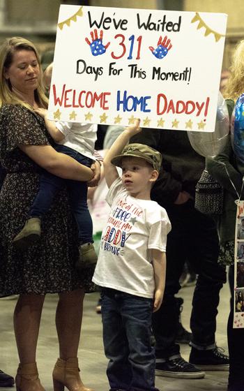 Parker Davis, 5. awaits the arrival of his father, Staff Sgt. Larry Davis, during a a welcome home ceremony for the 3rd Battalion, 197th Field Artillery Regiment on Feb. 8, 2024, at the Manchester, N.H., armory.