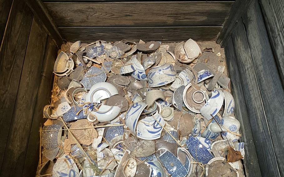A wooden box holds broken dishes at Fukagawa Edo Museum in Tokyo's Koto city.