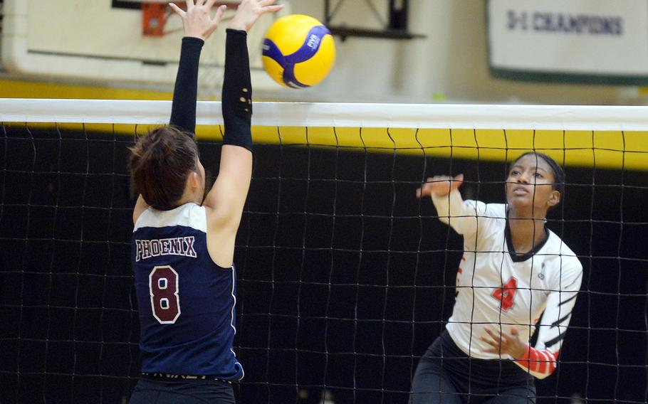 Seisen's Lisa Purcell reaches up to block a shot by E.J. King's Liz Turner during Friday's pool play in the 8th American School In Japan YUJO volleyball tournament. The Phoenix won in three sets.