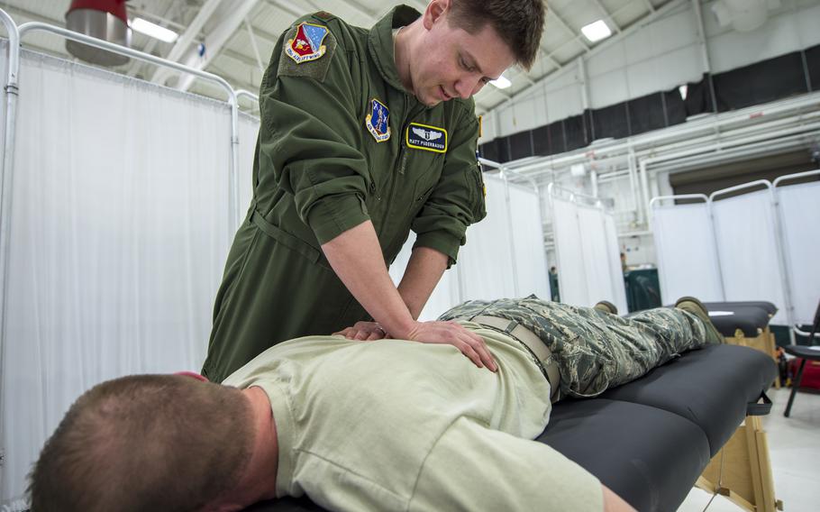 Air Force Maj. Matthew Puderbaugh, of the 133rd Medical Group, performs a musculoskeletal adjustment on an airman in St. Paul, Minn., in 2019. Between 31% and 44% of active-duty service members deal with chronic pain, the nonpartisan Rand Corp. said in a recent study, adding that back pain and joint disorders are the most common types of chronic pain experienced by troops. 