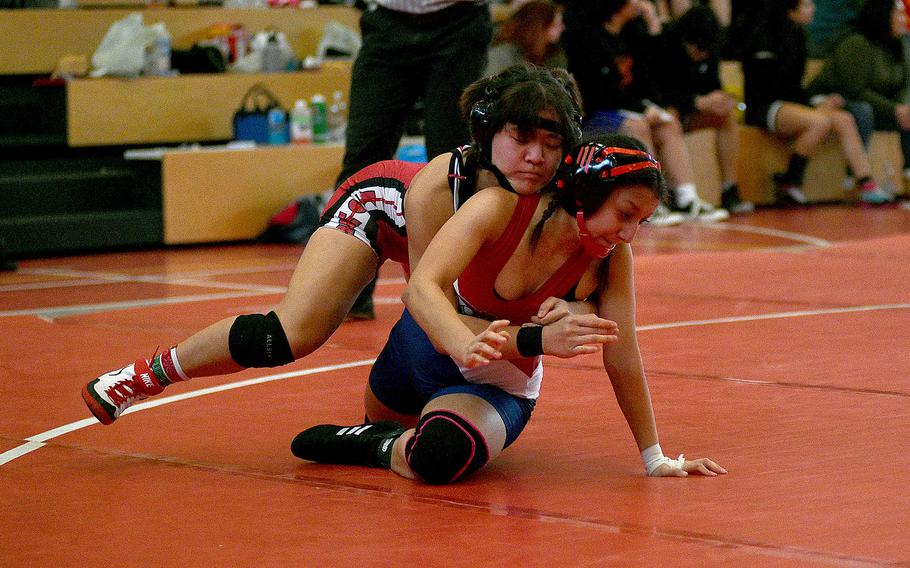 Kaiserslautern's Uno Tate grapples with Lakenheath's Natalia Maynes during a 113-pound match at a wrestling meet on Dec. 9, 2023, at Kaiserslautern High School in Kaiserslautern, Germany.