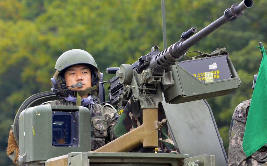 A gunman aboard a K1A1 tank waits for a firing order during training. 