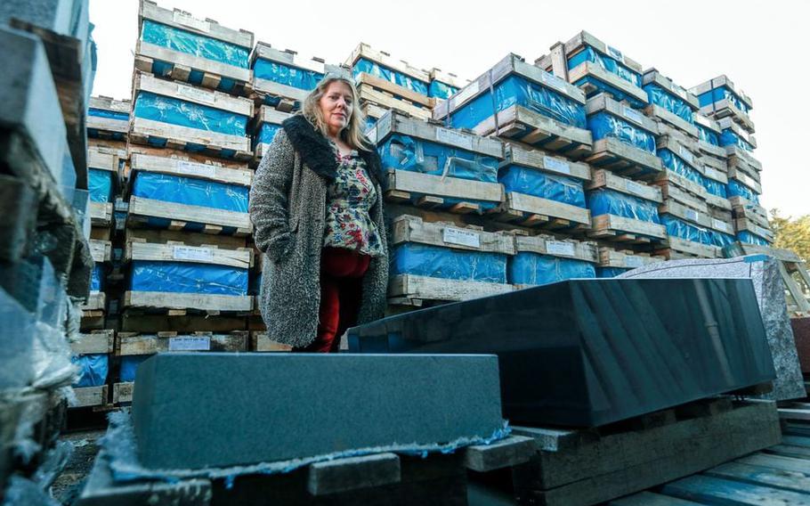 Darlene McMahon, marketing manager for Kani International Inc., stands with some gravestones stored at the facility in Hillsborough, N.J., on Wednesday, Dec., 13, 2024. McMahon says the company has about 15 unclaimed stones at their warehouse and they are trying to locate customers who were allegedly bilked thousands of dollars by another individual, for gravestones they never received.