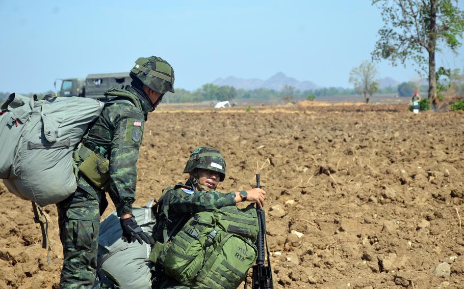 Thai paratroopers gather their chutes after landing in central Thailand, March 5, 2024, during the Cobra Gold exercise.